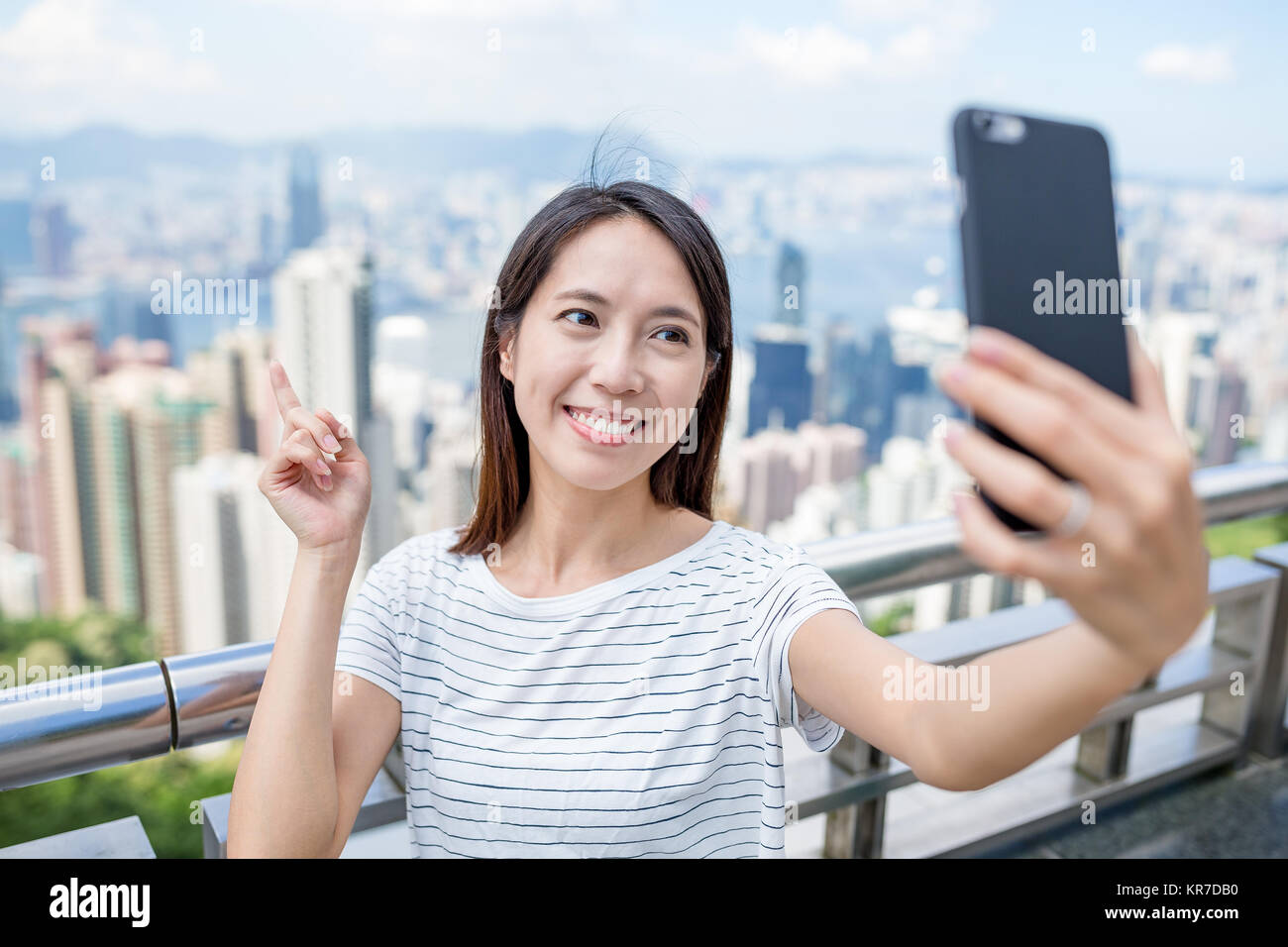 Woman taking selfie by cellphone in Hong Kong Stock Photo - Alamy