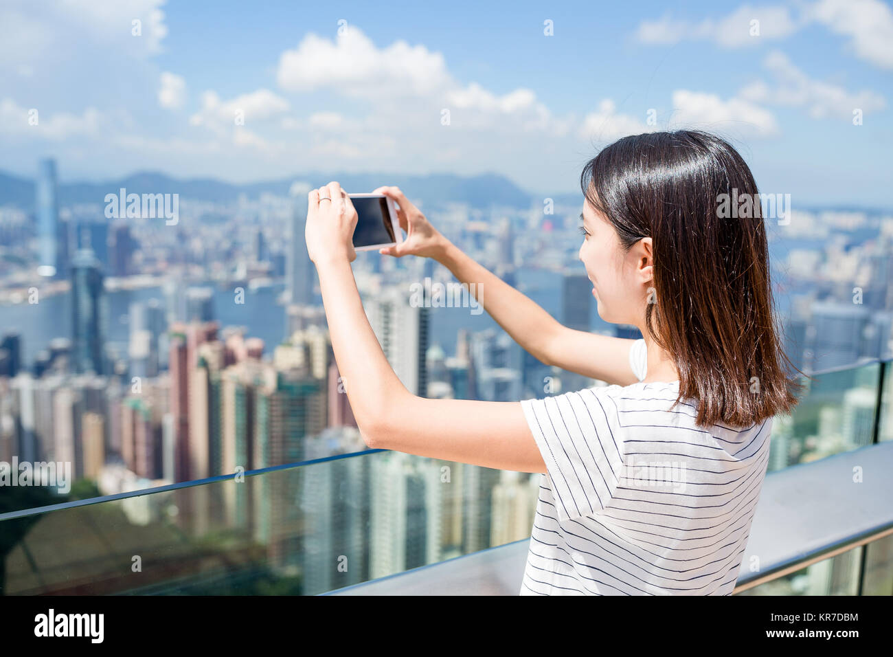 Woman taking photo in Hong Kong Stock Photo - Alamy