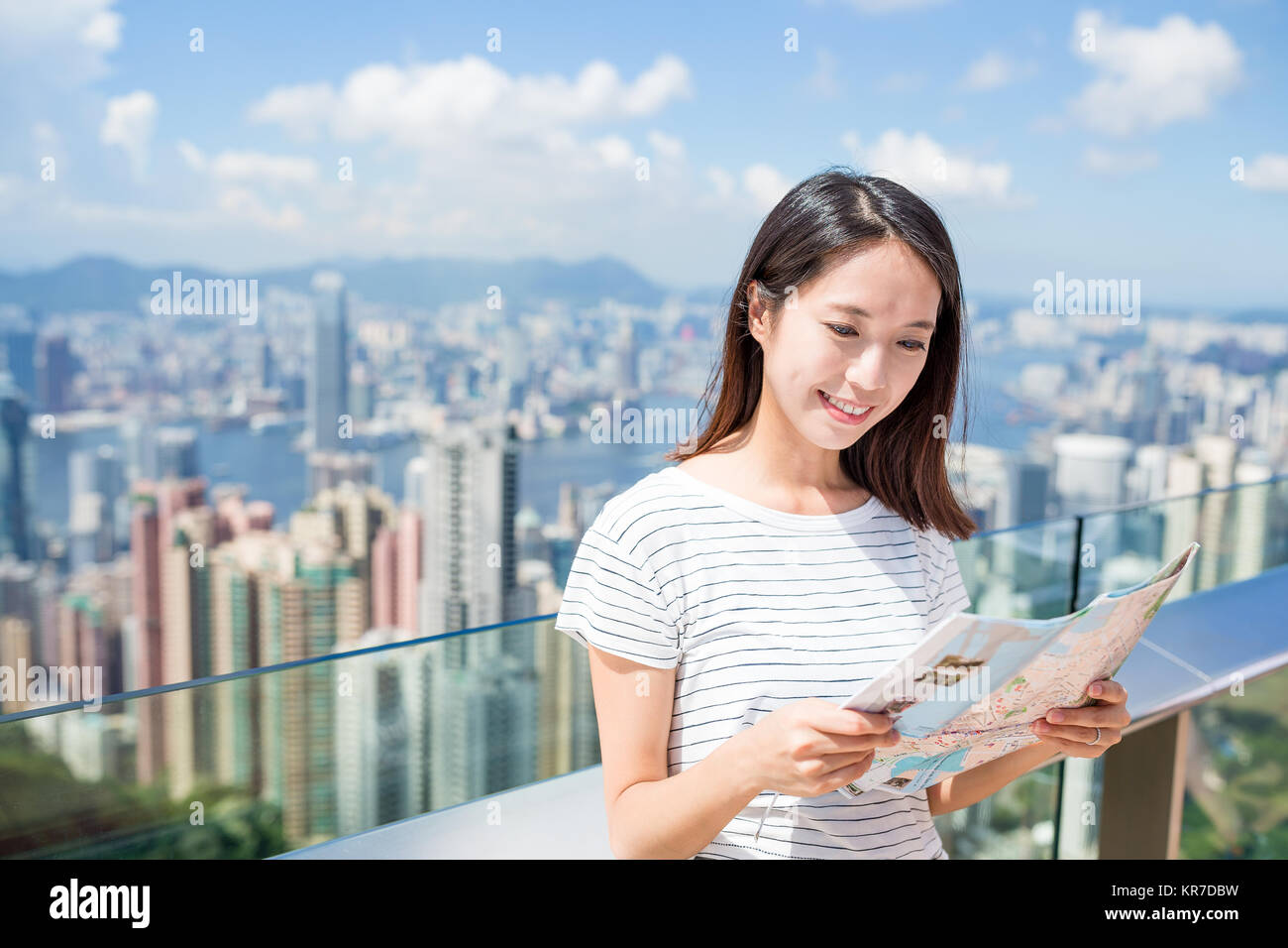 Woman looking at the city map in Hong Kong Stock Photo - Alamy