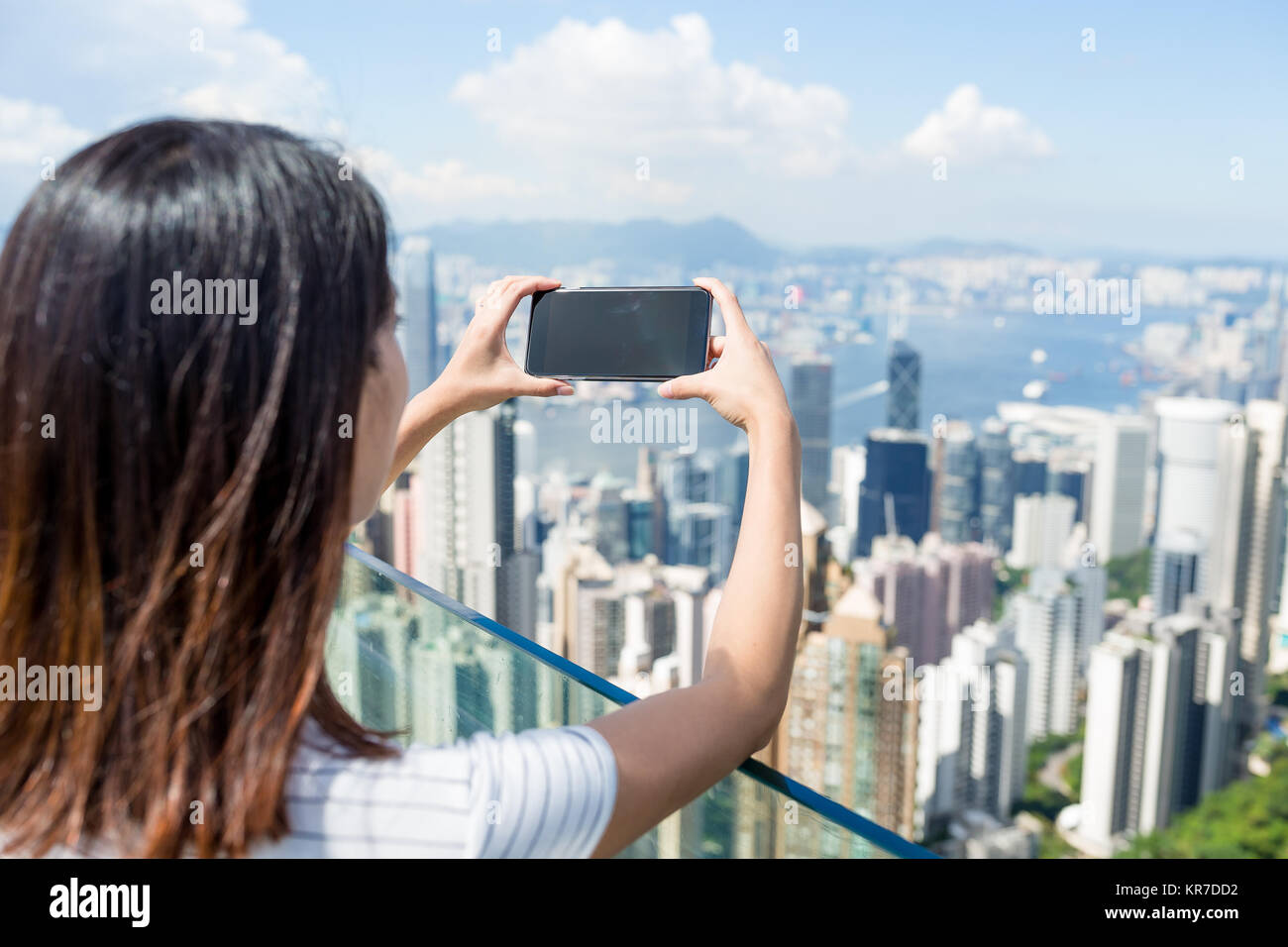 Woman taking photo of Hong Kong city Stock Photo - Alamy