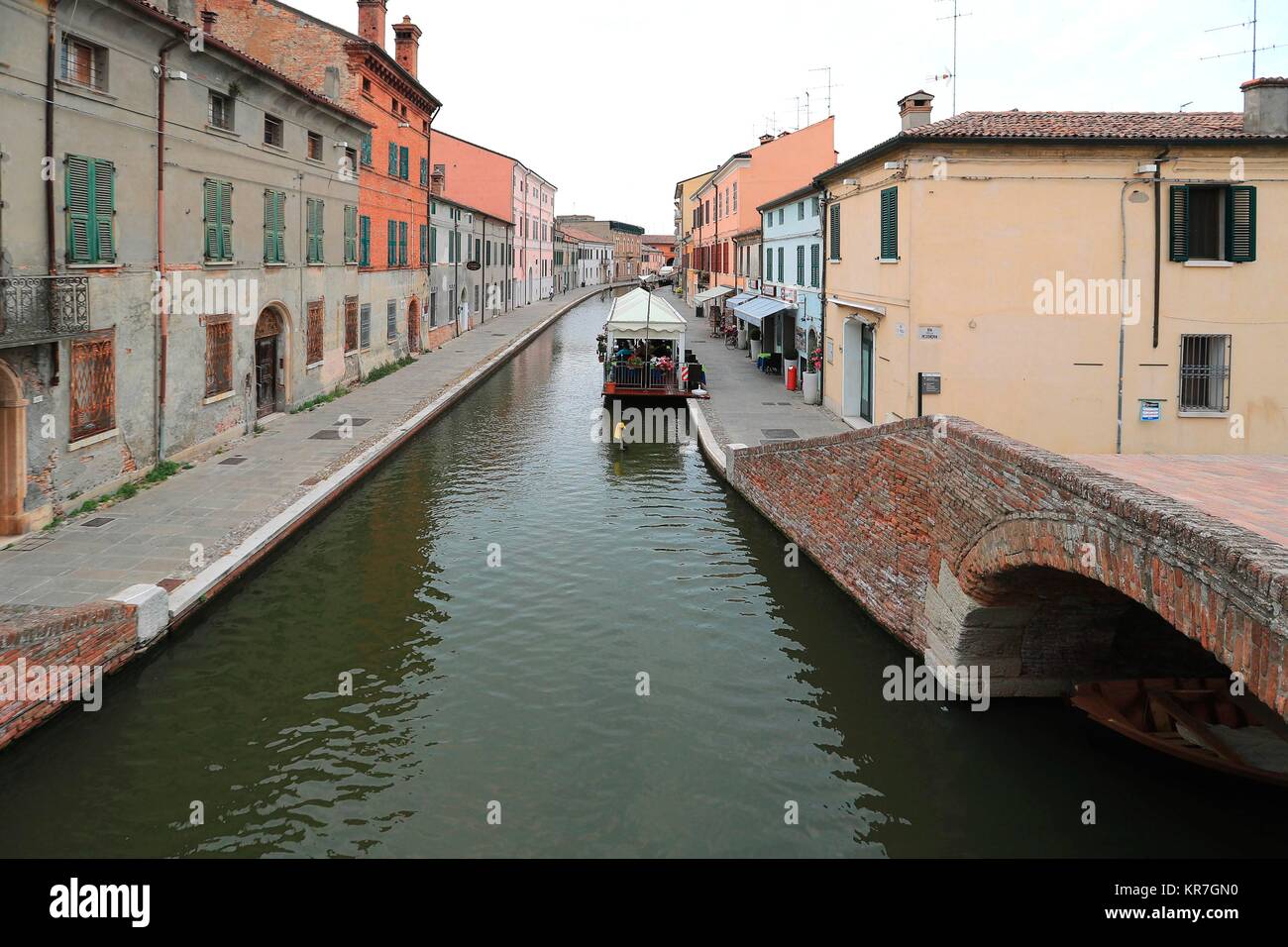 Canal with boat and colorful houses in Comacchio Village, Ferrara, Italy. June 14, 2017    Credit © Nuccio Goglia/Sintesi/Alamy Stock Photo Stock Photo