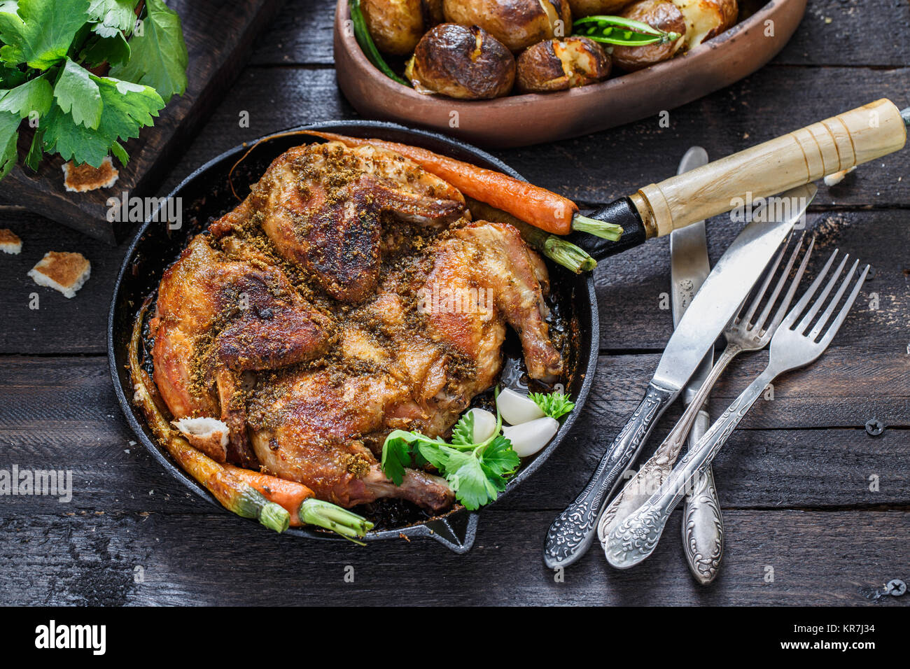 Whole roast chicken in an iron pan, rustic style, close view Stock