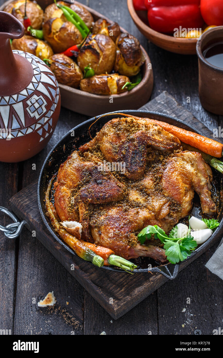 Whole roast chicken in an iron pan on dark background Stock Photo Alamy