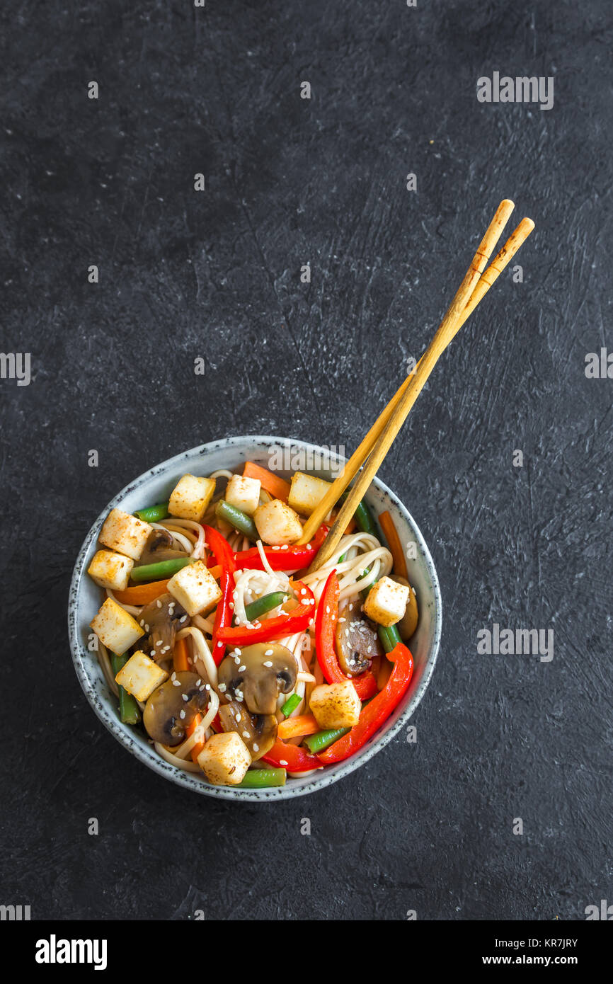 Stir fry with udon noodles, tofu, mushrooms and vegetables. Asian vegan vegetarian food, meal