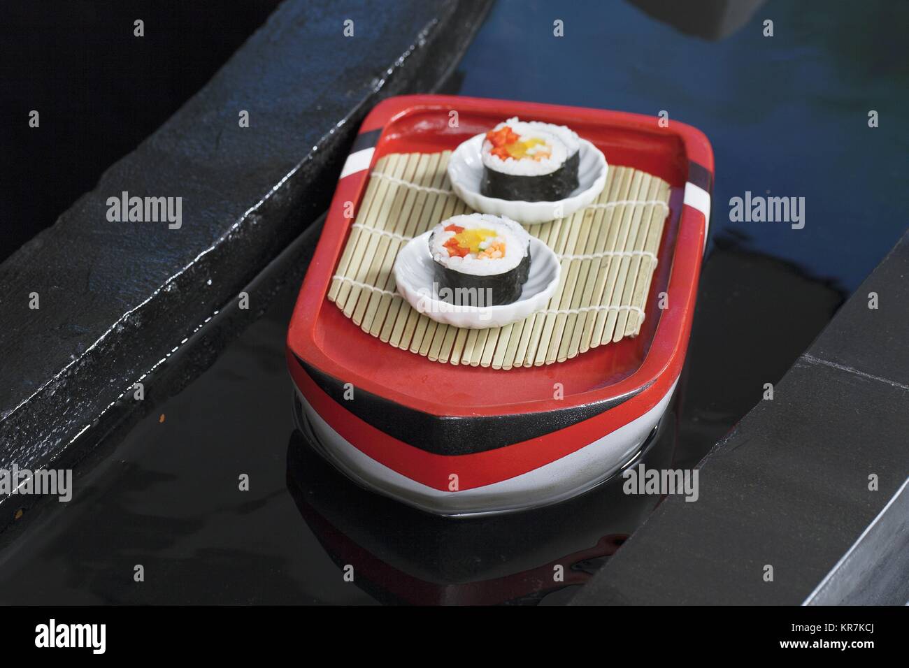 two shushi rolls in white plate Stock Photo - Alamy