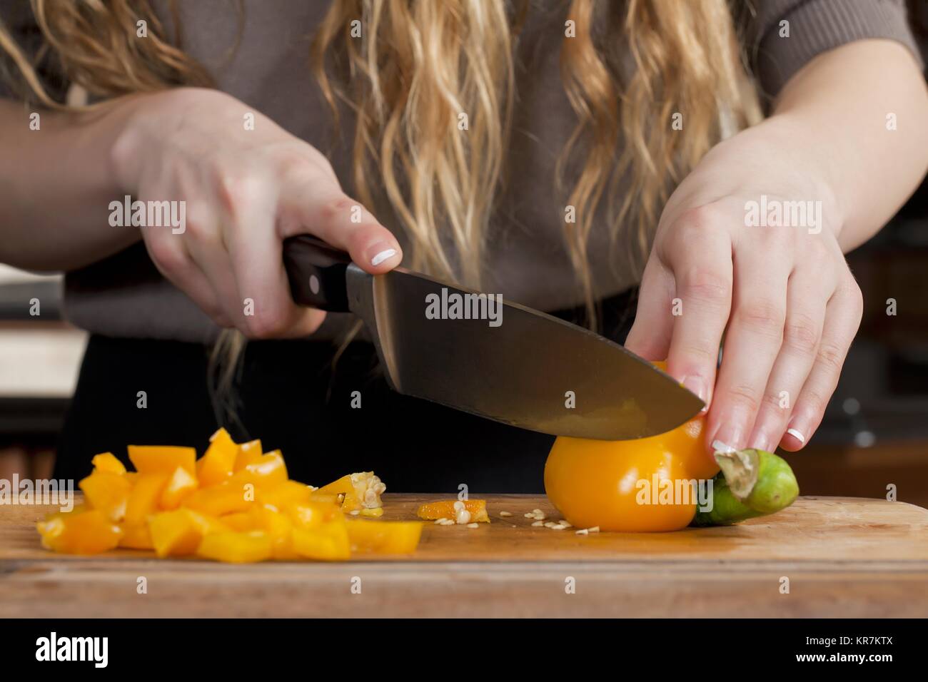 woman slicing bell pepper Stock Photo