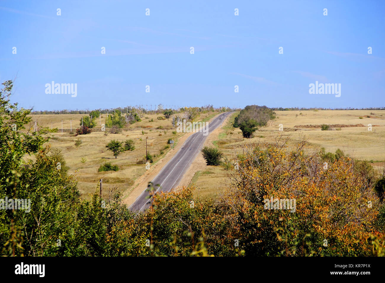 Summer landscape with line of road and blue sky Stock Photo - Alamy