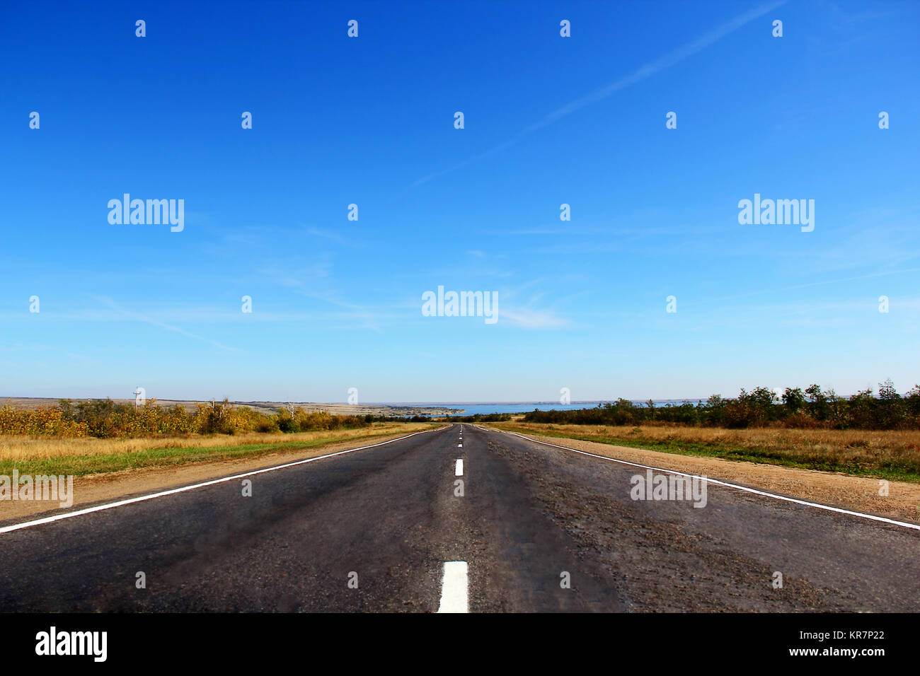 Summer landscape with line of road and blue sky Stock Photo - Alamy