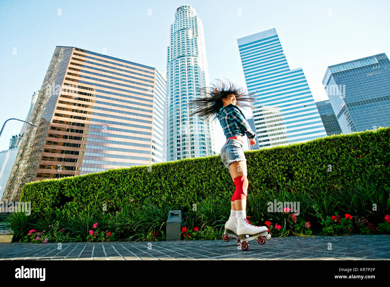 Asian woman rollerskating in city Stock Photo