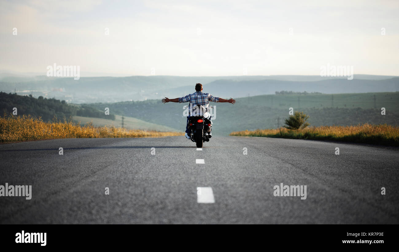 Caucasian man riding motorcycle with no hands Stock Photo Alamy