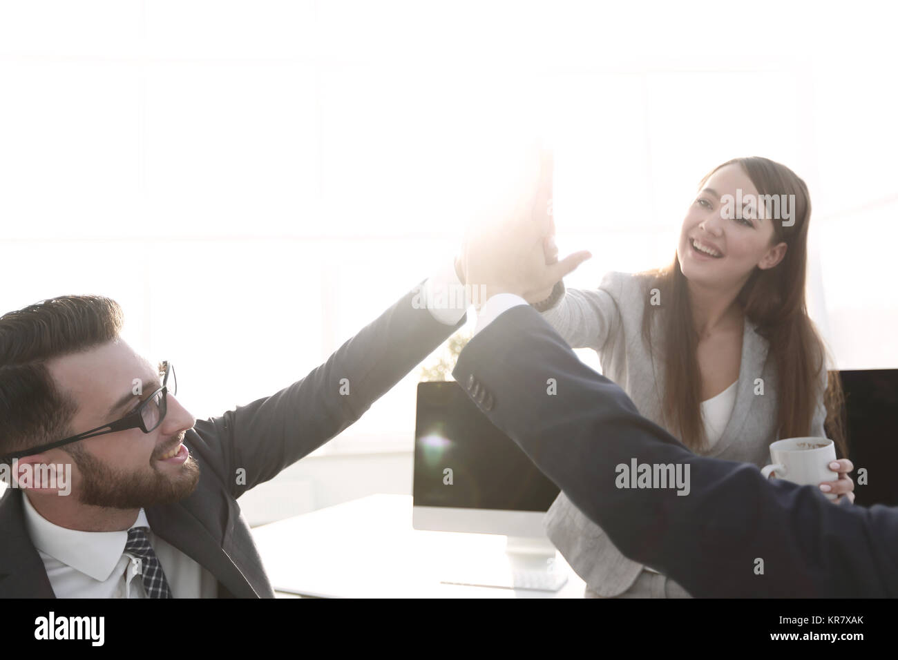 smiling colleagues giving each other high five Stock Photo - Alamy