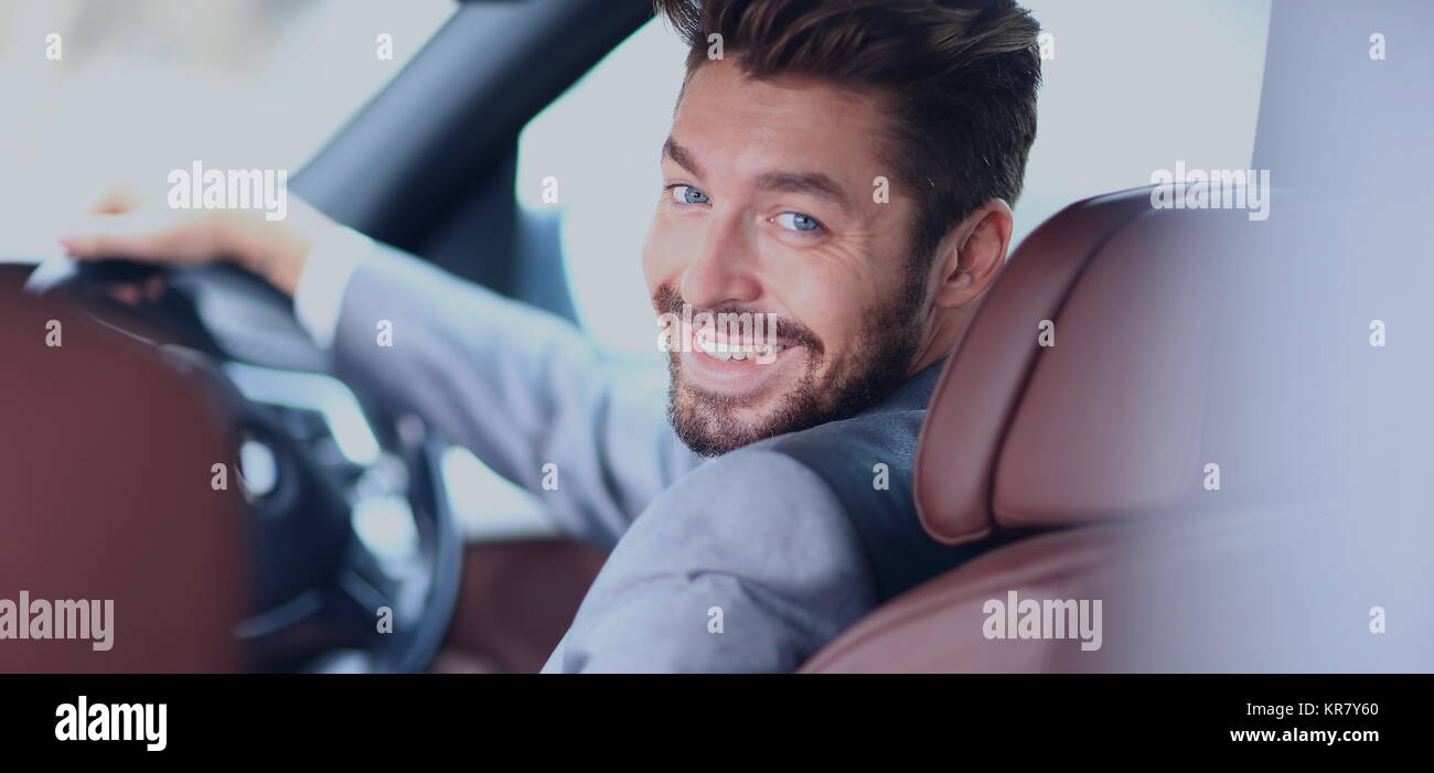 Portrait of an handsome smiling business man driving his car Stock ...