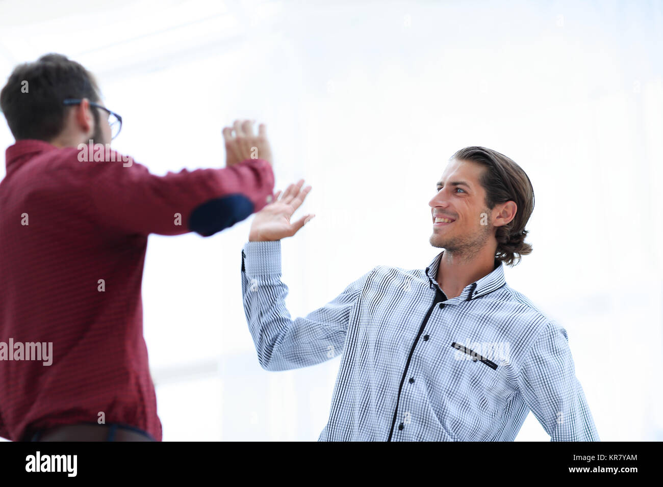 two business men giving each other a high five Stock Photo - Alamy