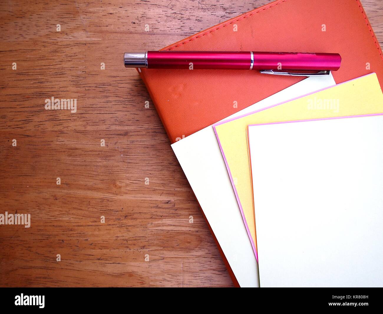 Photo of pen, notebook and colored papers Stock Photo