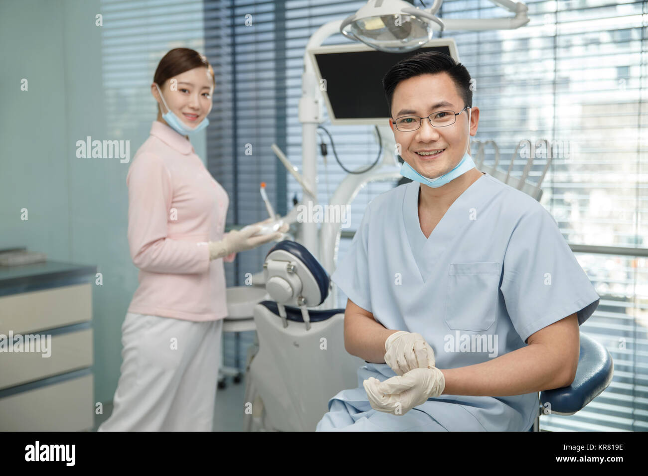 A male dentist and a dental assistant Stock Photo
