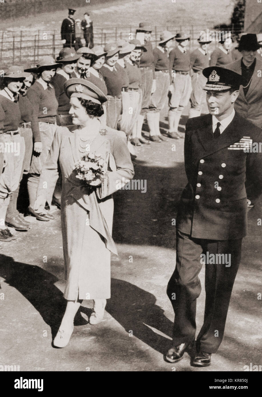 George VI and Queen Elizabeth inspecting members of the Women's Land Army in 1942 during WWII.  George VI, 1895 – 1952.  King of the United Kingdom and the Dominions of the British Commonwealth.   Queen Elizabeth, The Queen Mother.  Elizabeth Angela Marguerite Bowes-Lyon, 1900 – 2002.  Wife of King George VI and mother of Queen Elizabeth II. Stock Photo