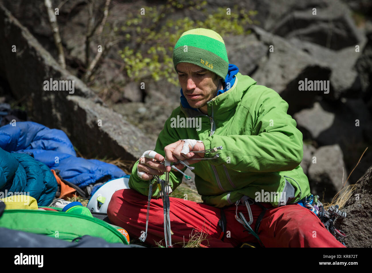 A rock climber prepares his equipment Stock Photo