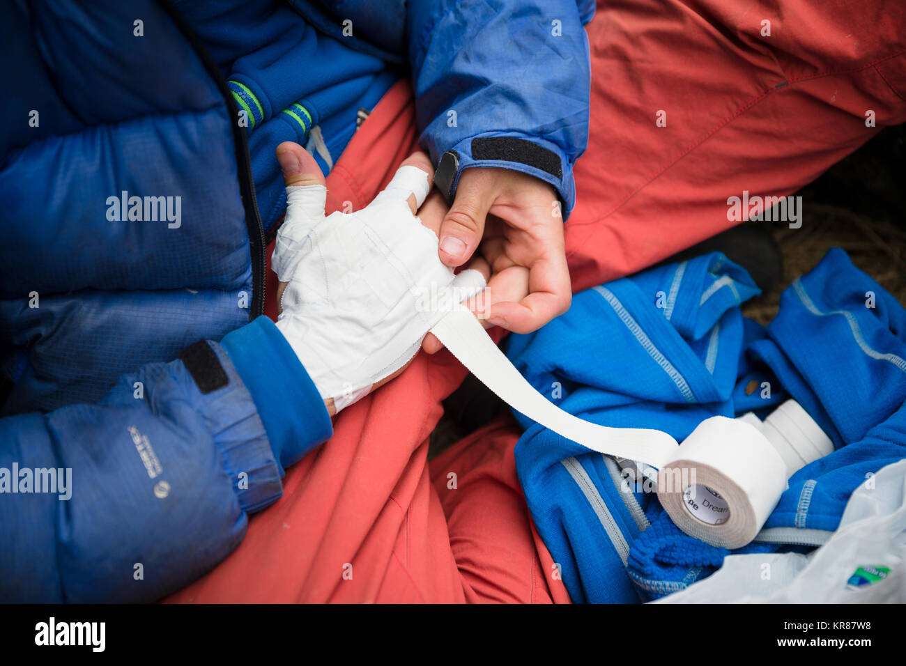 Close up of hands being taped up in preparation for climbing a crack