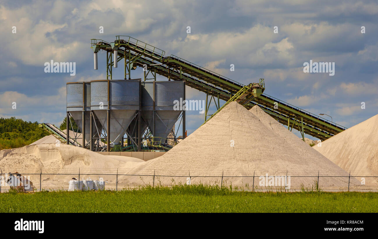 Sand mining terminal with conveyer belts and silos on a summer day Stock Photo