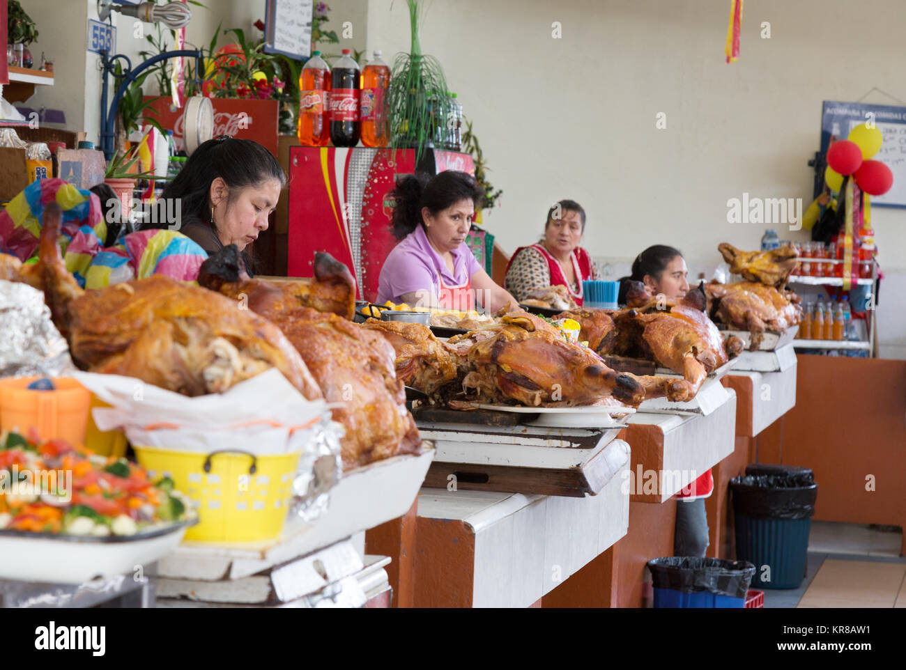 Women selling hog roast meat for lunch, Cuenca indoor food market