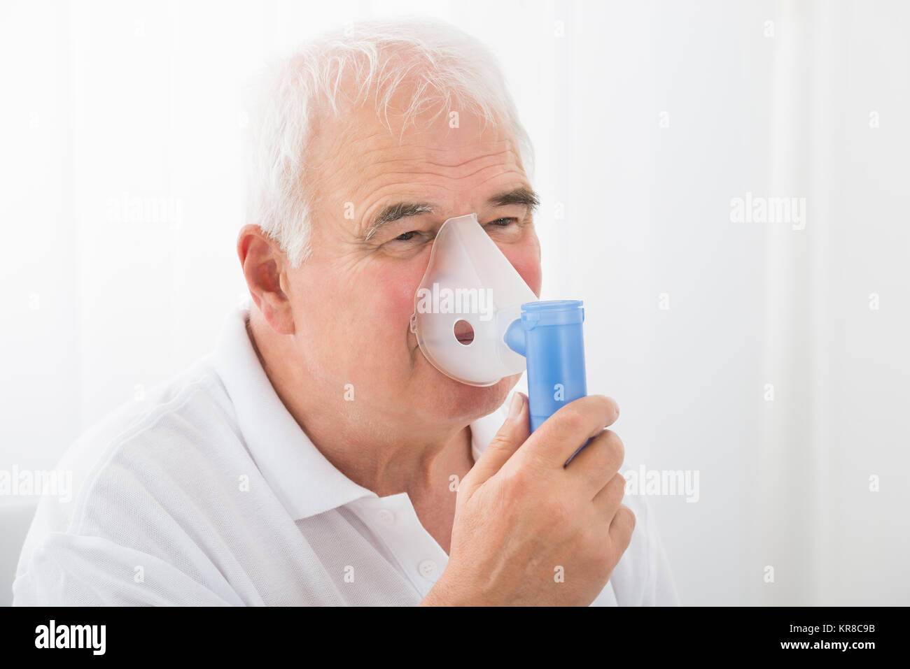 Man Inhaling Through Oxygen Mask Stock Photo Alamy