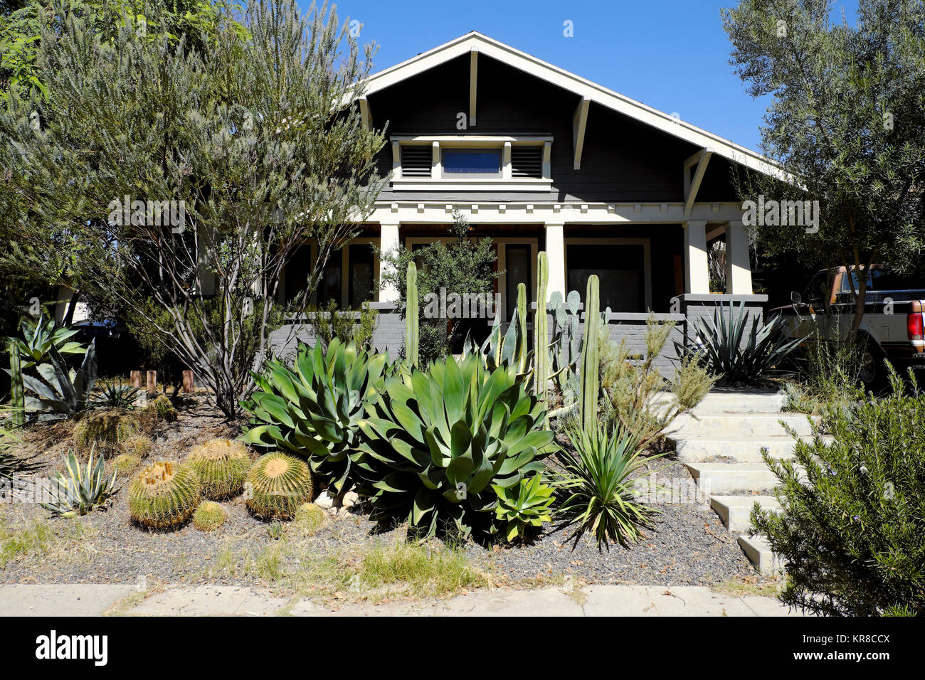 A typical California style house exterior with cactus front garden in ...