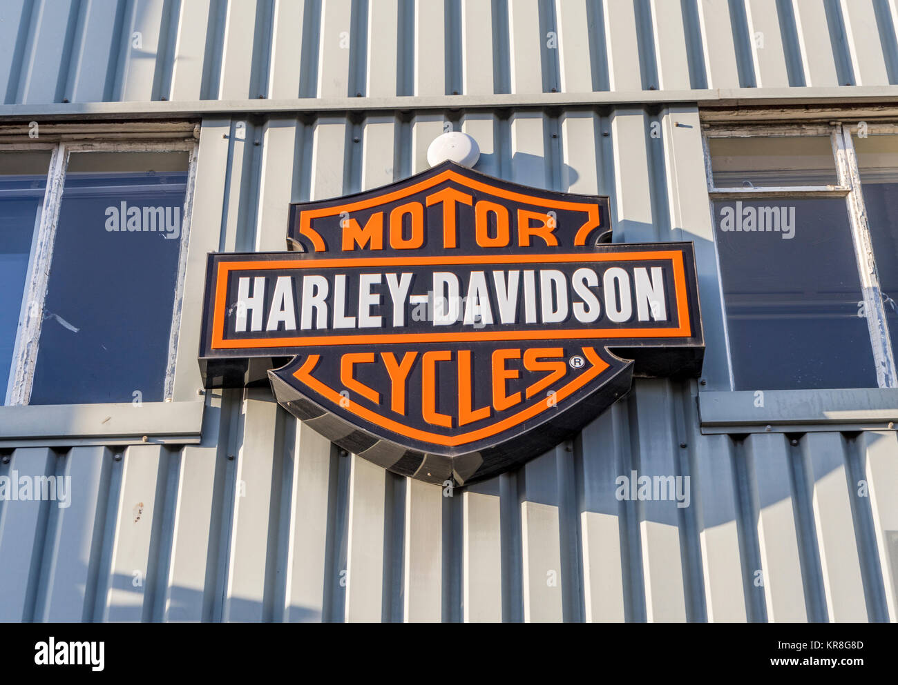 Orange/ white Harley Davidson Motorcycles sign on a UK shop Stock Photo