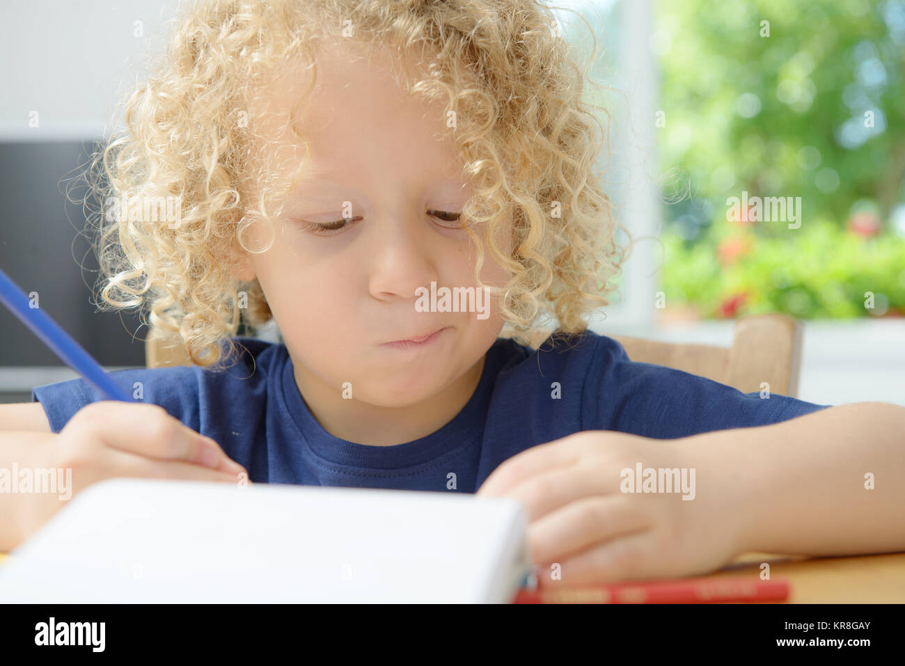 boy drawing on a notebook Stock Photo Alamy