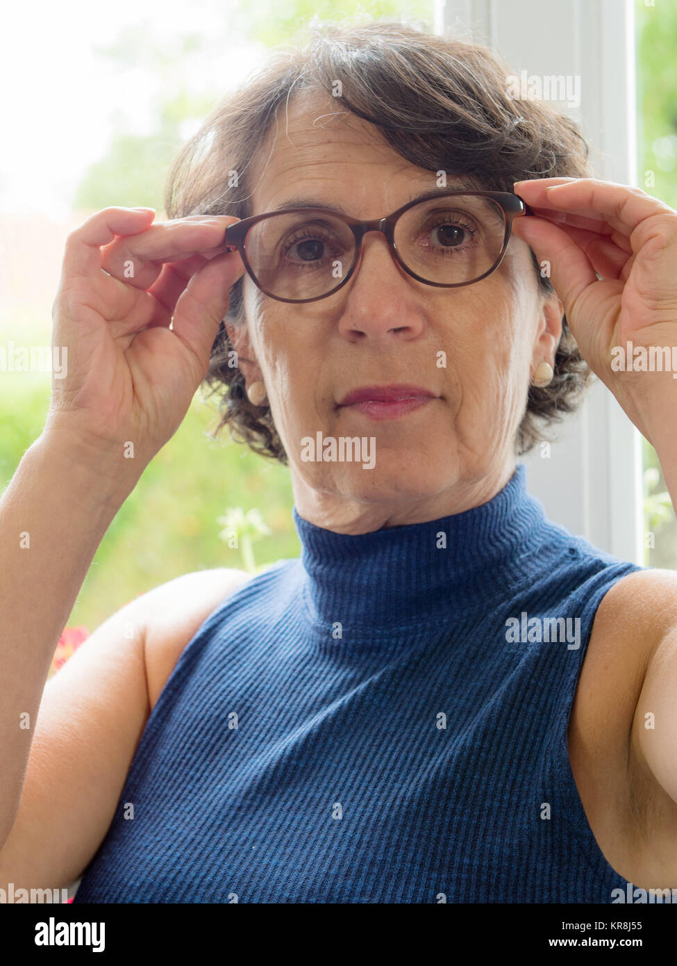 portrait of a mature woman with glasses Stock Photo - Alamy
