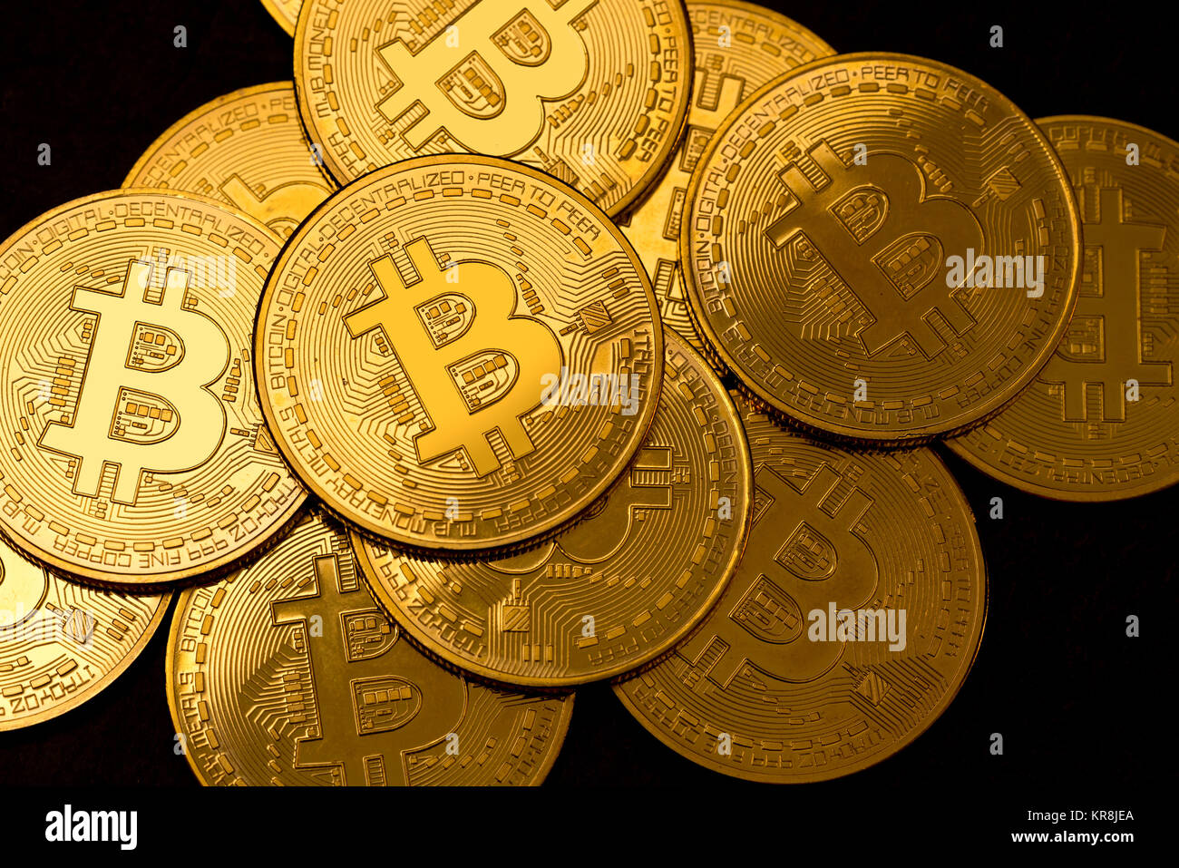 Pile of bitcoins on a black slate background Stock Photo