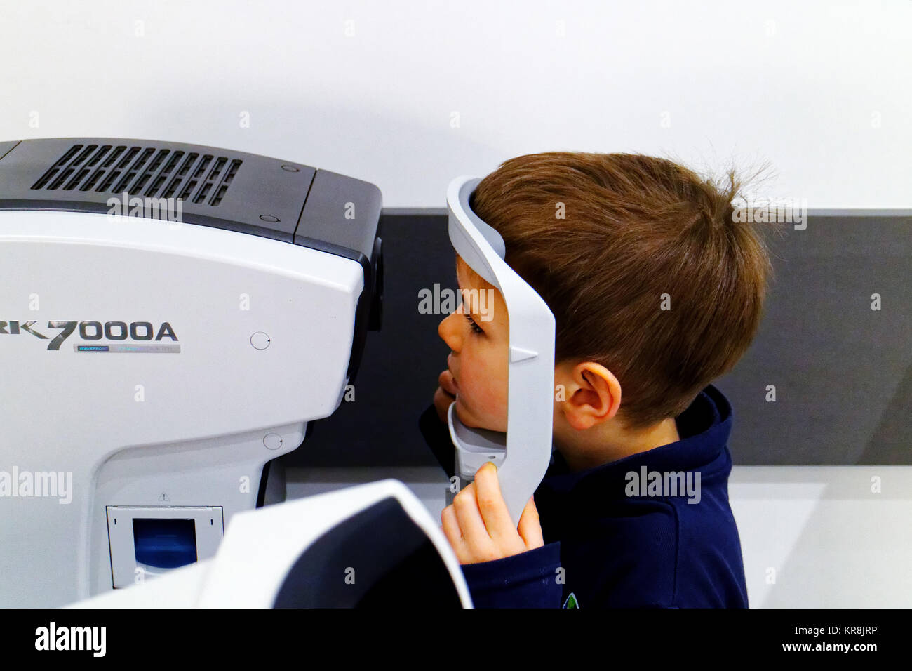 A young boy (5 yr old) having his first eye test Stock Photo