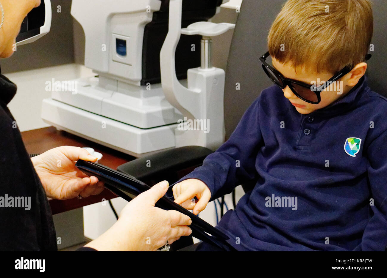 A young boy (5 yr old) having his first eye test Stock Photo