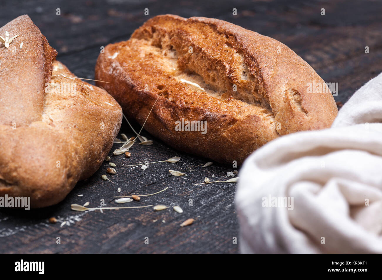 Rustic bread on wood table. Dark moody background with free text space ...