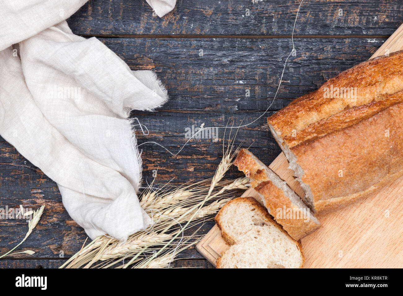 Rustic bread on wood table. Dark woody background with free text space. Stock Photo