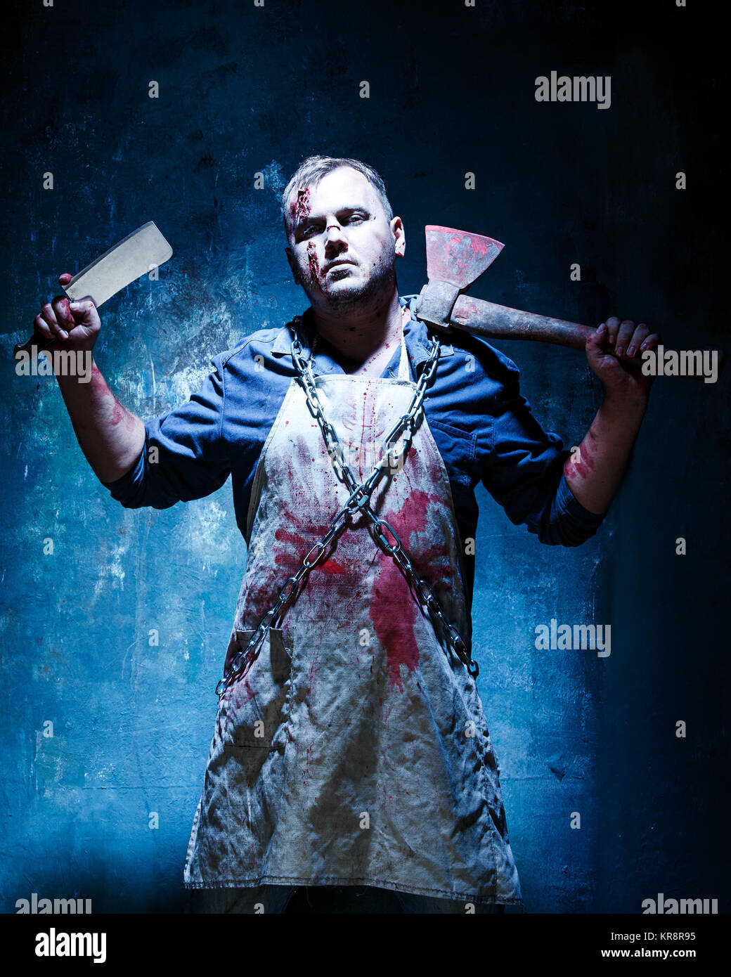 Bloody Halloween theme: crazy killer as butcher with an ax Stock Photo