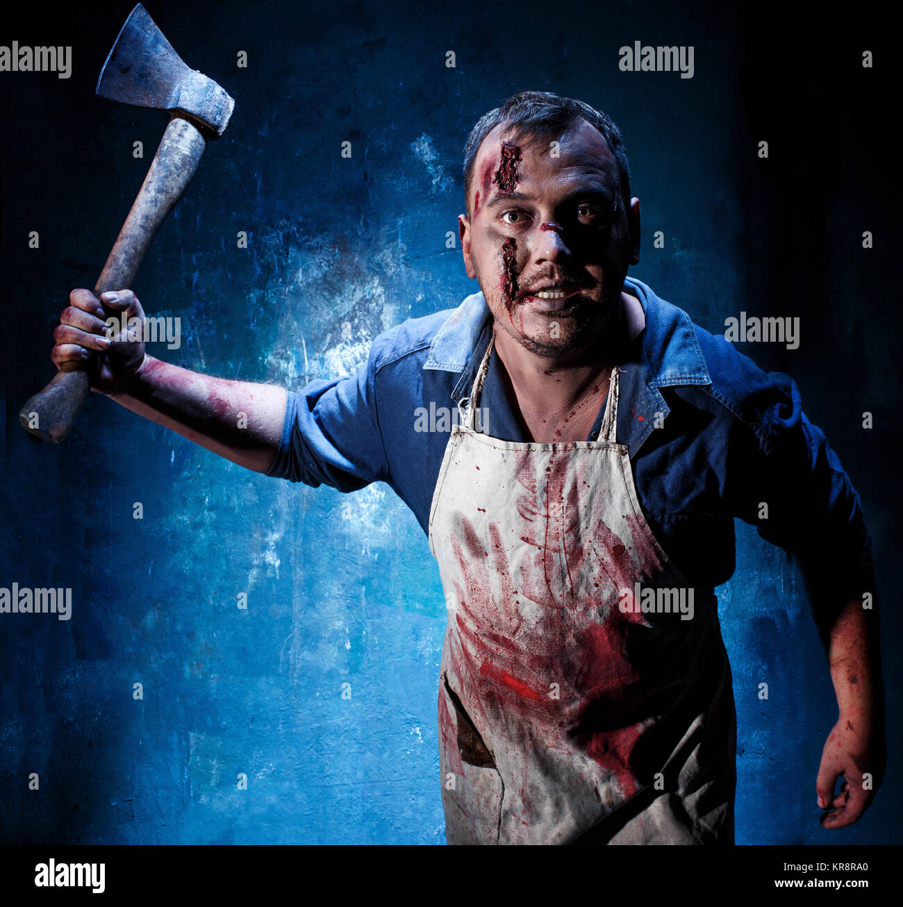 Bloody Halloween theme: crazy killer as butcher with an ax Stock Photo