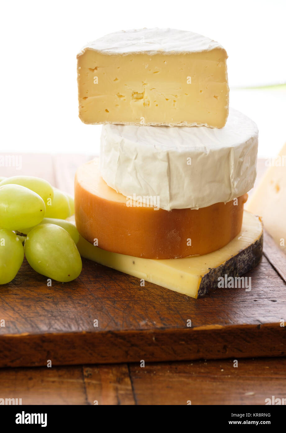 Assorted cheeses with grapes Stock Photo