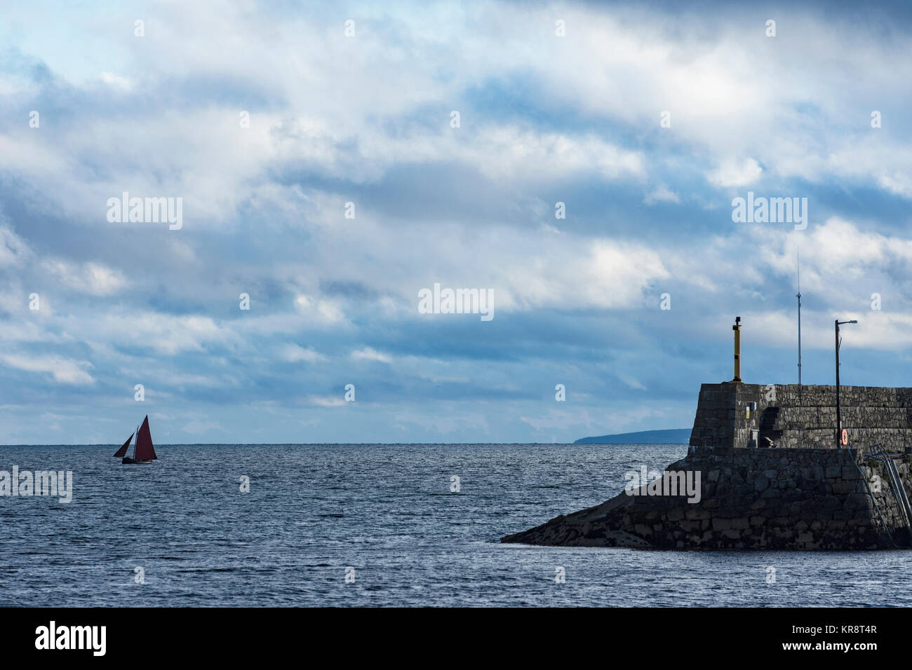 Ireland, Galway County, Spiddal, Hooker sailboat and pier Stock Photo