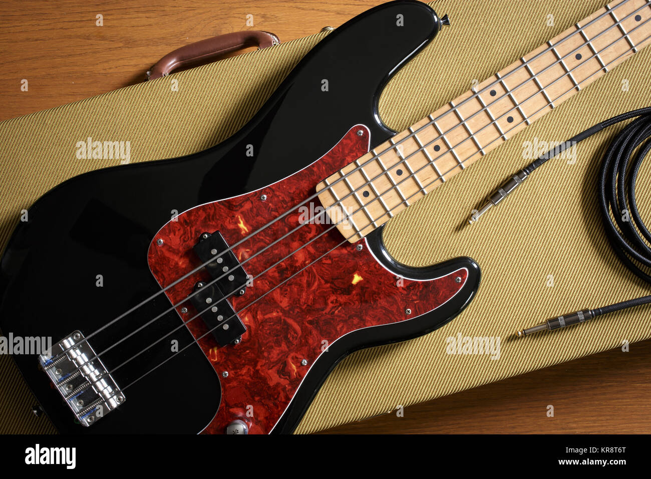 Bass guitar and cable lying on guitar case Stock Photo Alamy