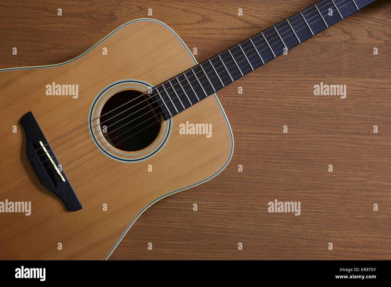 Acoustic guitar lying on floor Stock Photo