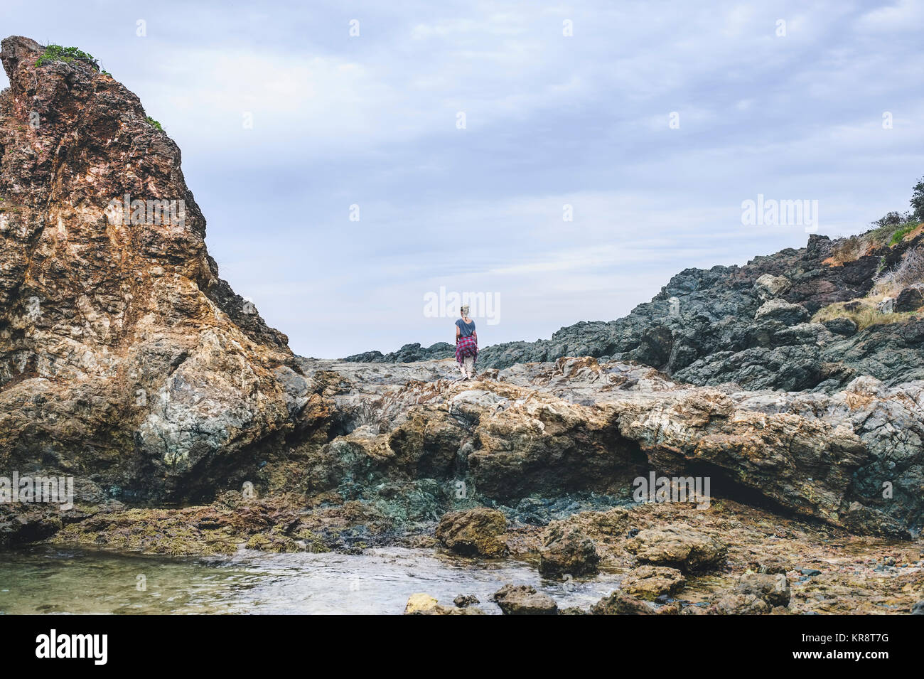 Australia, New South Wales, Woman standing on cliff and looking at view Stock Photo