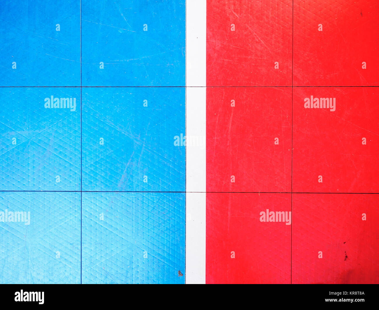 Red and blue tiled floor of basketball court Stock Photo