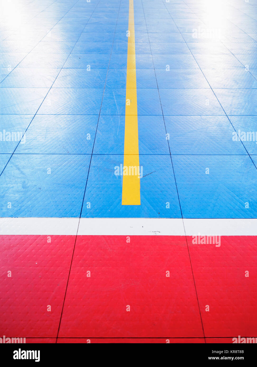 Red and blue tiled floor of basketball court Stock Photo