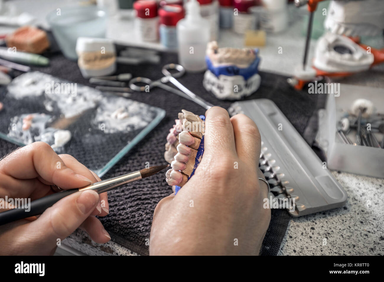 Dental technician applying ceramics Stock Photo Alamy