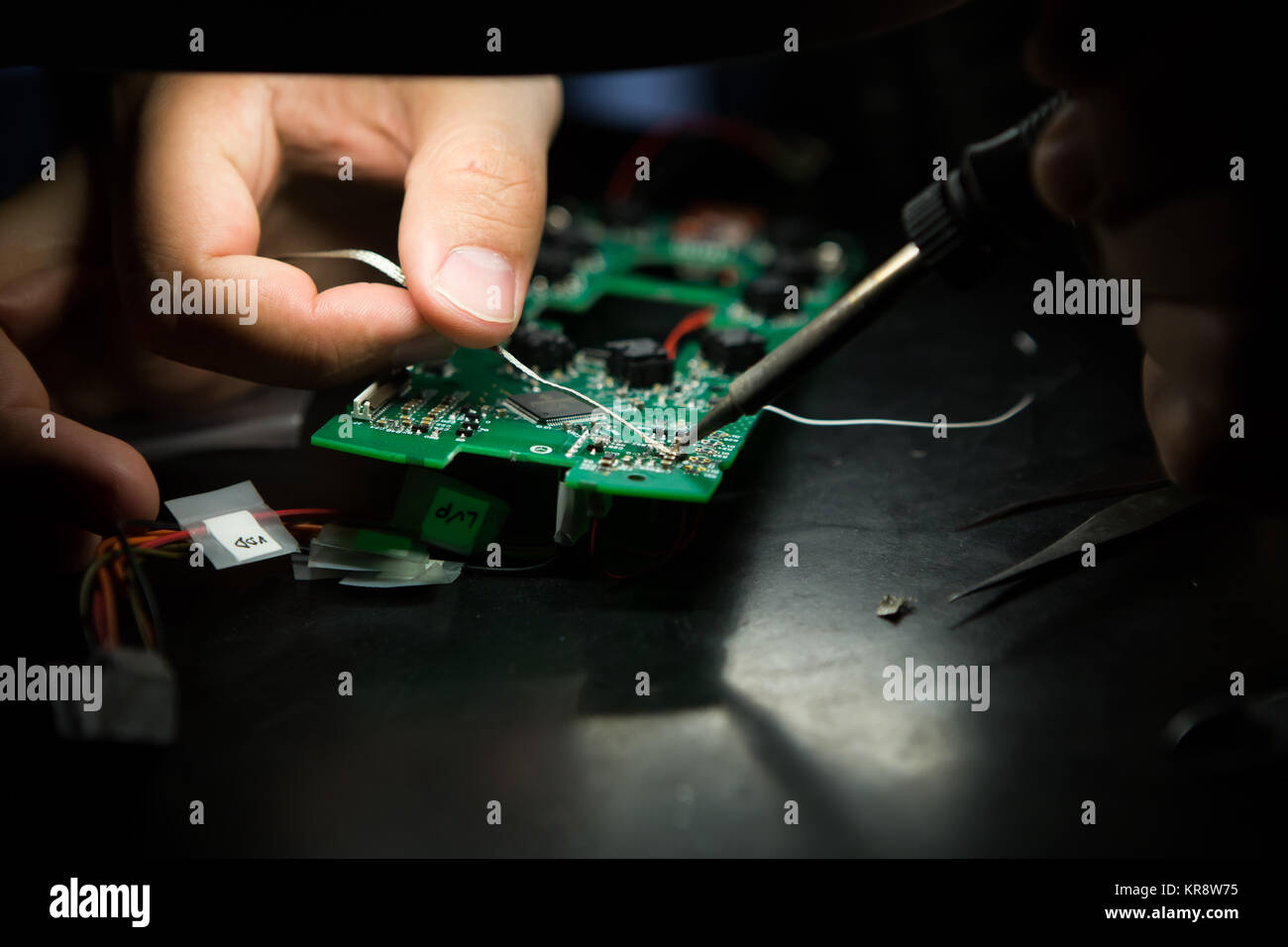 An engineer is working on an electronic device Stock Photo