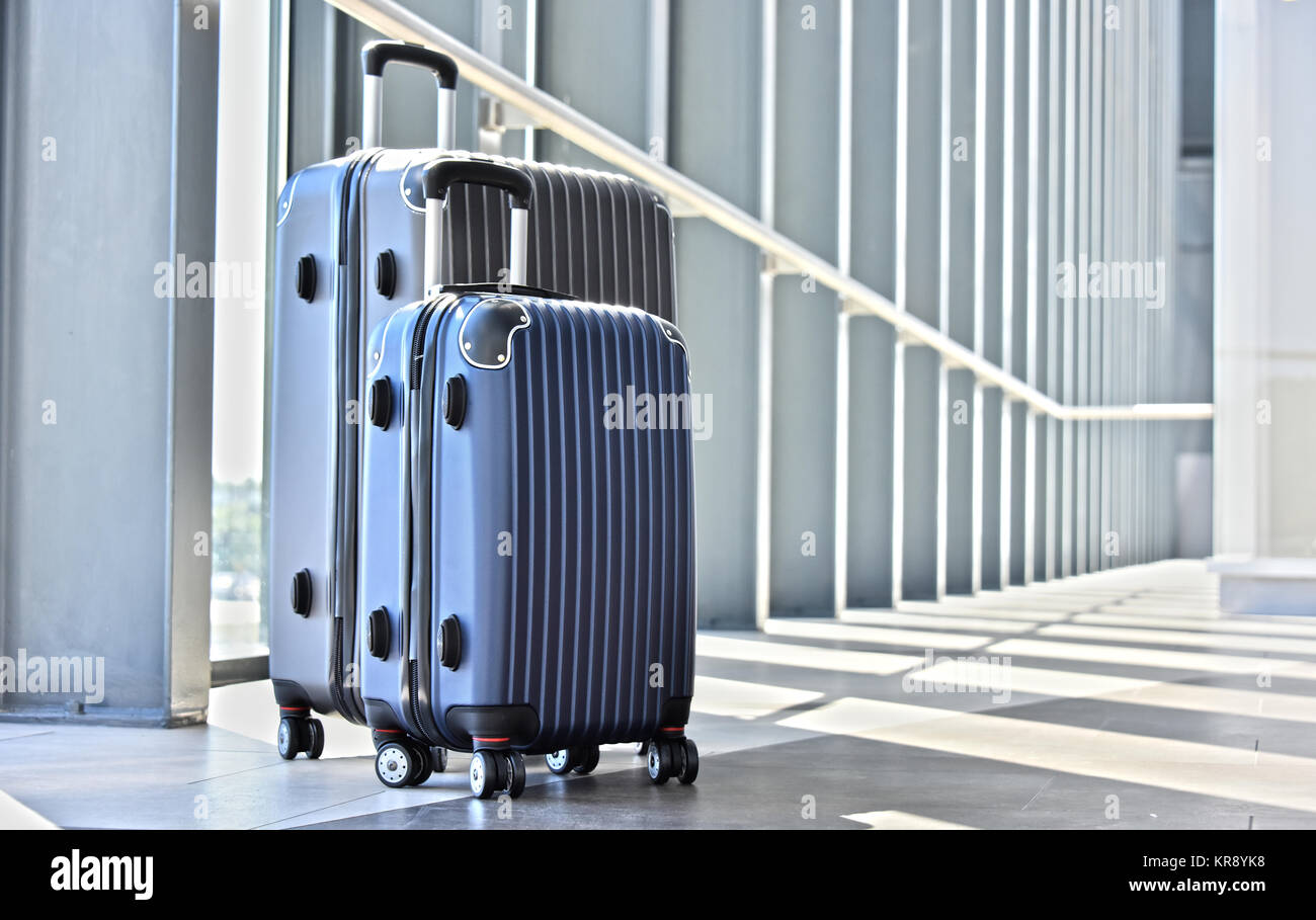 Two plastic travel suitcases in the airport hall Stock Photo Alamy