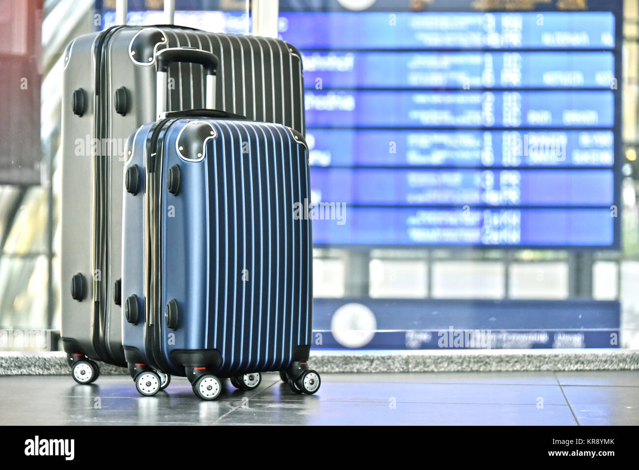 Two plastic travel suitcases in the airport hall Stock Photo Alamy