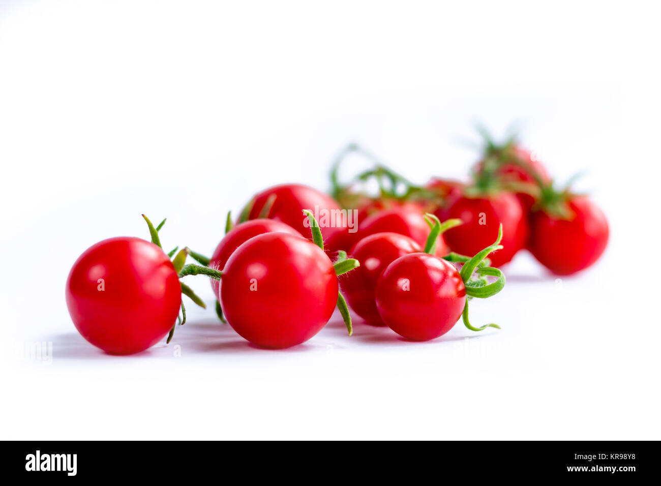 Cluster of cherry tomatoes on white background Stock Photo