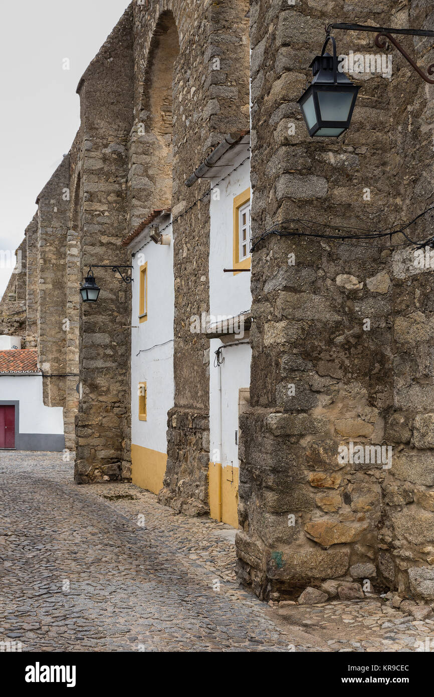 Agua de Prata. Houses built into the arches of the Evora Aqueduct. Portugal. Stock Photo