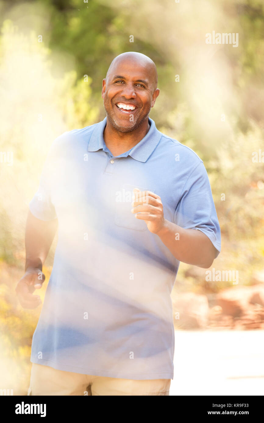 African American man jogging outside. Stock Photo